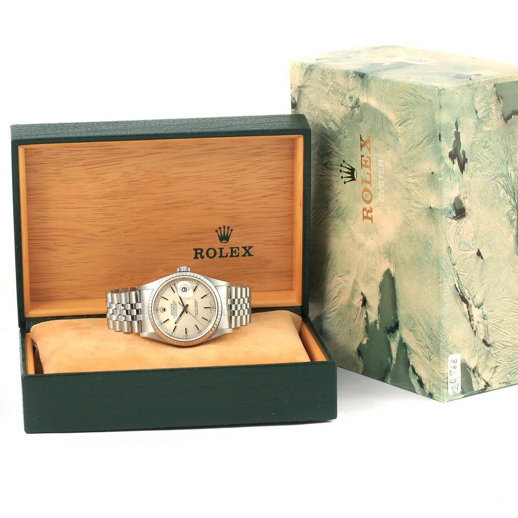 The image shows a Rolex Datejust 16220 Men
s Stainless Steel Silver Dial 16220 Men
s Stainless Steel Silver Dial watch placed inside an open Rolex watch box with its sleeve box beside it.