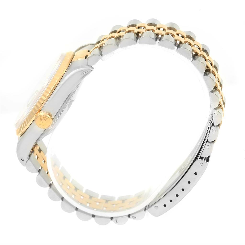 The image shows a side view of a Rolex Datejust 16233 Men's Steel and Gold (two tone) Champagne Dial 16233 Men's Steel and Gold (two tone) Champagne Dial watch, highlighting the crown, case, and Jubilee bracelet.