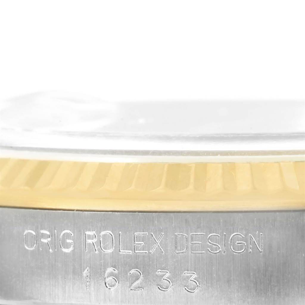 The image shows a close-up of the side of a Rolex Datejust 16233 Men's Steel and Gold (two tone) Beige Dial 16233 Men's Steel and Gold (two tone) Beige Dial watch, featuring the engraved reference number and part of the bezel.
