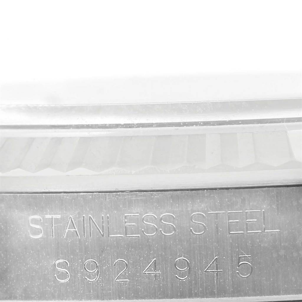 The image shows a close-up of the serial number and "STAINLESS STEEL" inscription on the case side of a Rolex Datejust 16234 Men
s Stainless Steel Silver Dial 16234 Men
s Stainless Steel Silver Dial watch.
