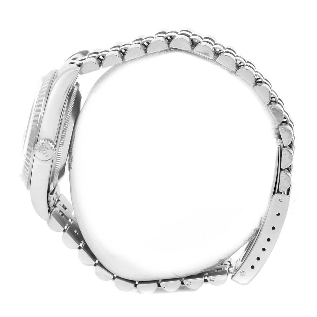 This side view of the Rolex Datejust 16234 Men
s Stainless Steel Silver Dial 16234 Men
s Stainless Steel Silver Dial watch shows the crown, case, and part of the bracelet.