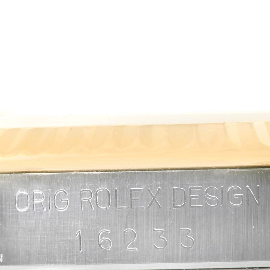 The image shows a close-up of the side of a Rolex Datejust 16233 Men's Steel and Gold (two tone) Champagne Dial 16233 Men's Steel and Gold (two tone) Champagne Dial watch with the model number 16233 engraved on the metal.