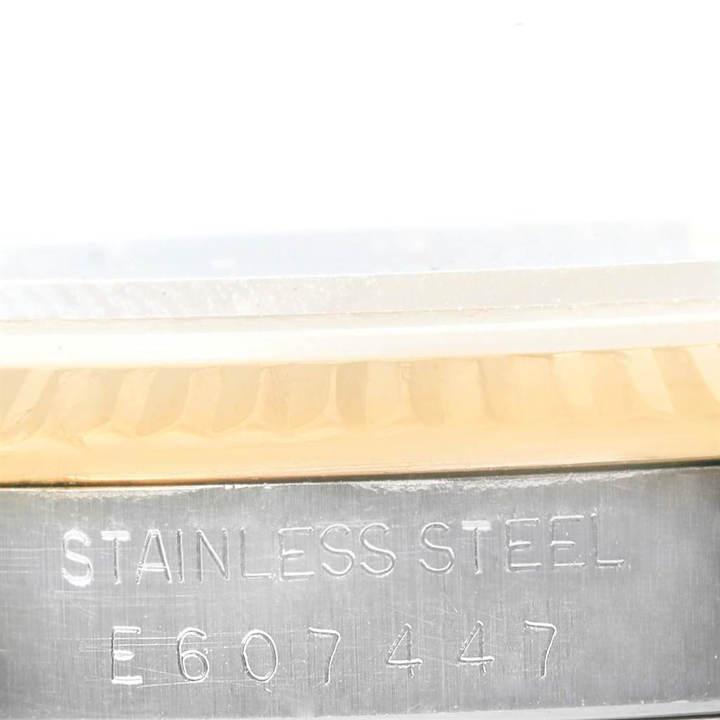 The image shows a close-up of the side of the case and the serial number of a Rolex Datejust 16233 Men's Steel and Gold (two tone) Champagne Dial 16233 Men's Steel and Gold (two tone) Champagne Dial watch.