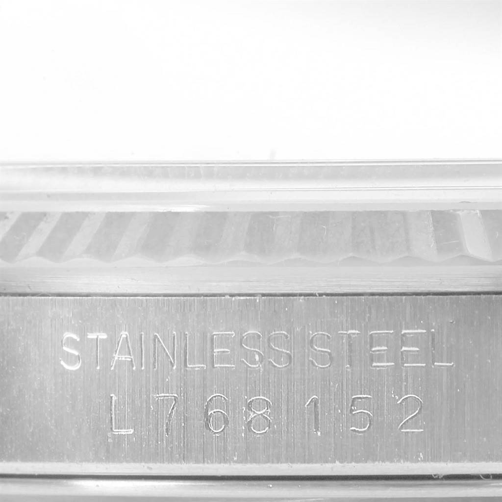 This image shows a close-up of the watch case of a Rolex Datejust 16234 Men
s Stainless Steel Silver Dial 16234 Men
s Stainless Steel Silver Dial, highlighting the "STAINLESS STEEL" engraving and serial number.
