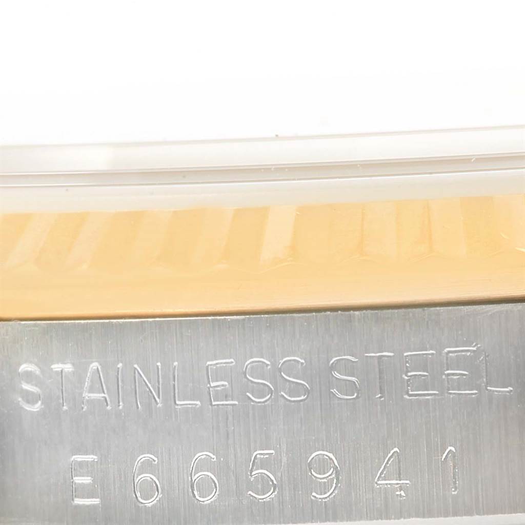 The image shows a close-up of the model and serial number engraving on the case of a Rolex Datejust 16233 Men's Steel and Gold (two tone) Champagne Dial 16233 Men's Steel and Gold (two tone) Champagne Dial watch.