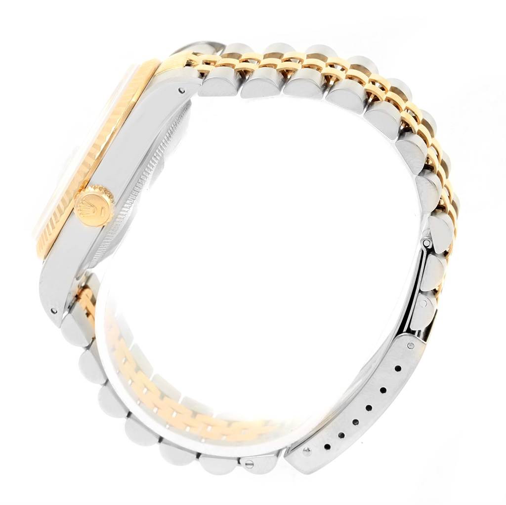 The image shows a side angle view of the Rolex Datejust 16233 Men's Steel and Gold (two tone) Champagne Dial 16233 Men's Steel and Gold (two tone) Champagne Dial watch, highlighting its crown, case, and two-tone bracelet.