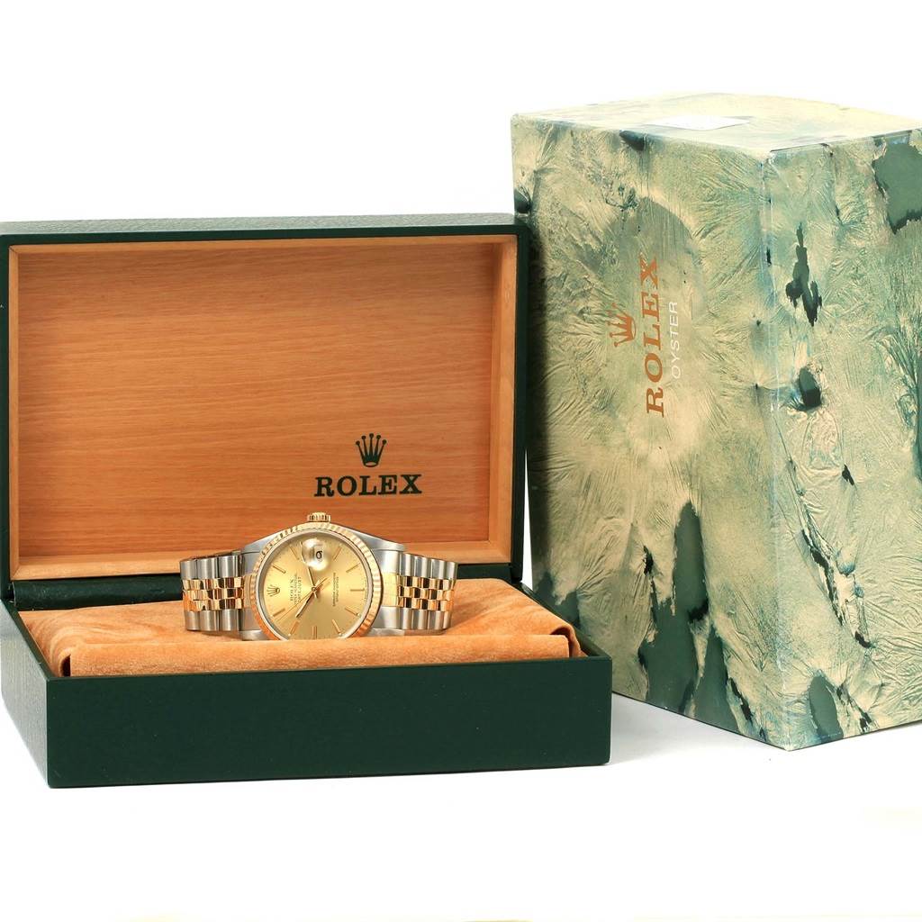The Rolex Datejust 16233 Men's Steel and Gold (two tone) Champagne Dial 16233 Men's Steel and Gold (two tone) Champagne Dial watch is shown in its open box, along with an outer box to the right.