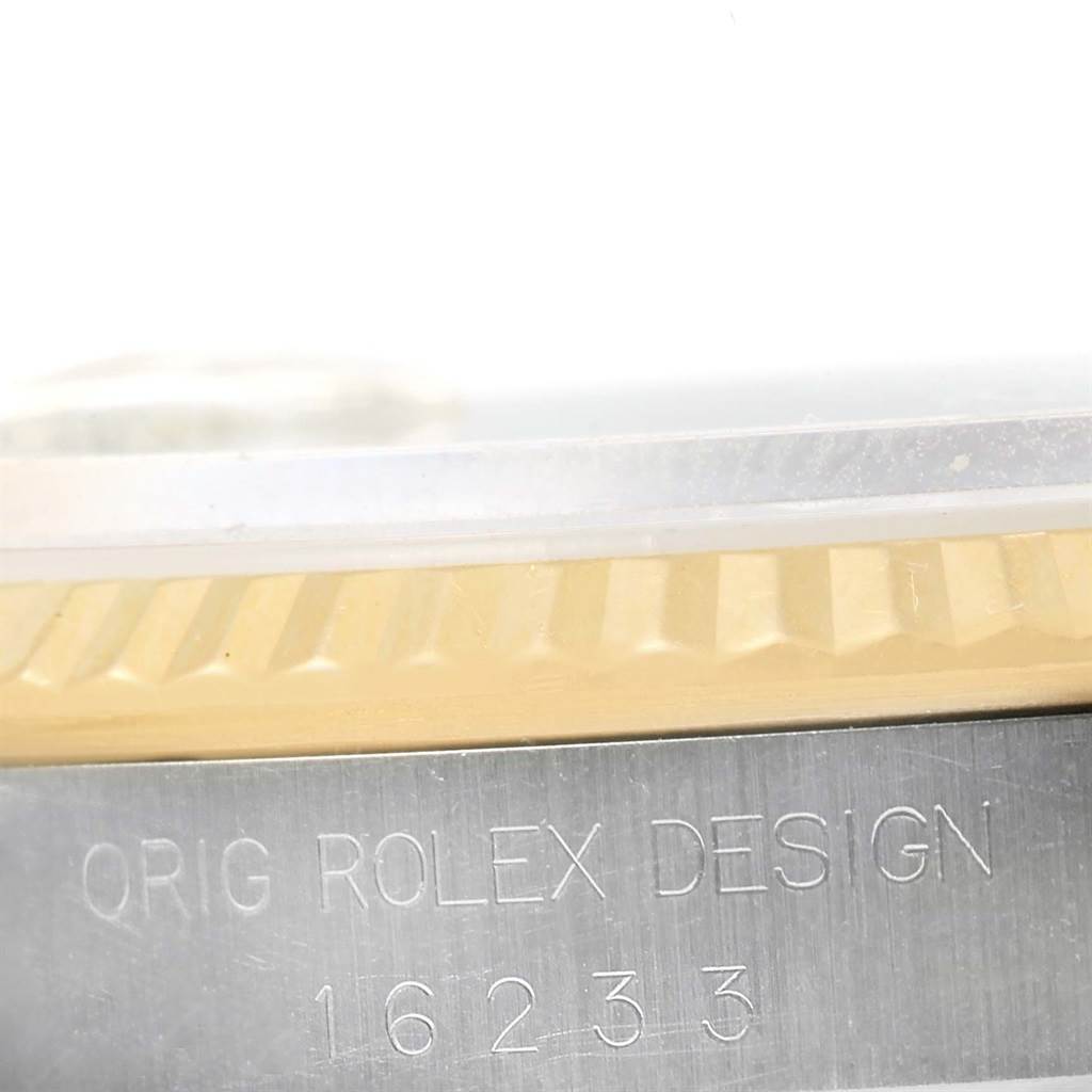 The image shows a close-up of the side view of a Rolex Datejust 16233 Men
s Steel and Gold (two tone) Black Dial 16233 Men
s Steel and Gold (two tone) Black Dial, highlighting the bezel and case with engraved model number 16233.