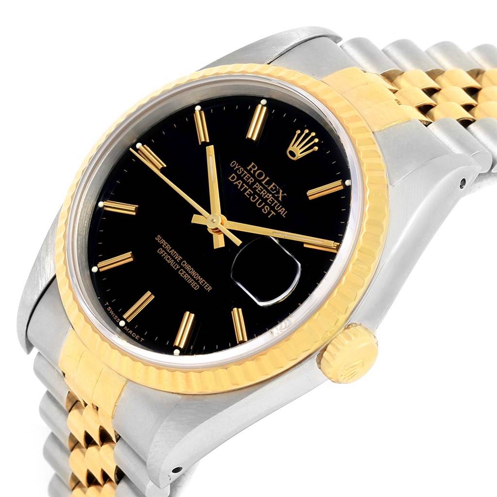 The image shows a Rolex Datejust 16233 Men
s Steel and Gold (two tone) Black Dial 16233 Men
s Steel and Gold (two tone) Black Dial watch at a slight side angle with a black dial, gold fluted bezel, and two-tone Jubilee bracelet.