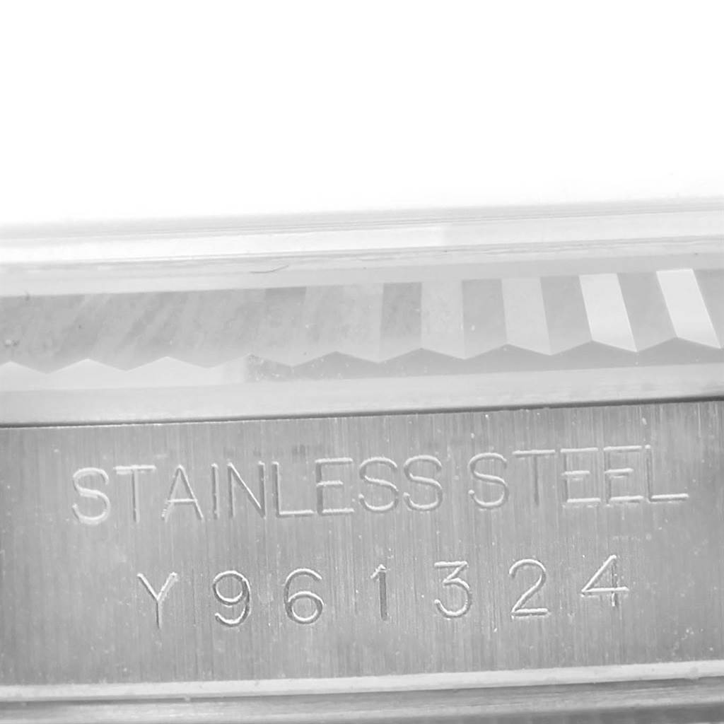 This image shows a close-up of the serial number engraving and fluted bezel on a Rolex Datejust 16234 Men's Stainless Steel Silver Dial 16234 Men's Stainless Steel Silver Dial watch.