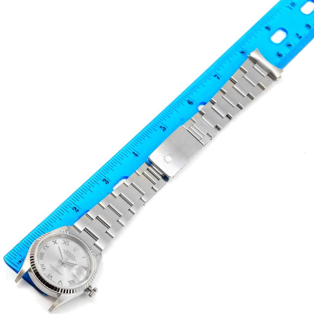 The image shows a Rolex Datejust 16234 Men's Stainless Steel Silver Dial 16234 Men's Stainless Steel Silver Dial watch with a full view of its face, bracelet, and clasp, measured against a blue ruler.