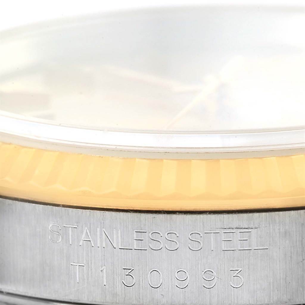 This image shows a close-up of the side of a Rolex Datejust 16233 Men's Steel and Gold (two tone) Champagne Dial 16233 Men's Steel and Gold (two tone) Champagne Dial watch, focusing on the stainless steel case and the edge of the bezel.