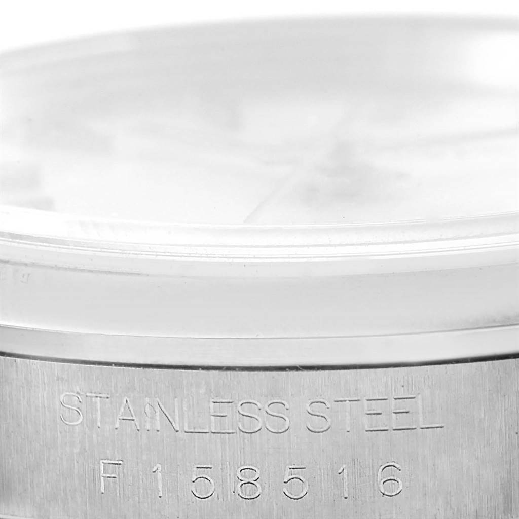 The image shows the side view of a Rolex Datejust 16200 Men's Stainless Steel Silver Dial 16200 Men's Stainless Steel Silver Dial watch's casing, highlighting the stainless steel engraving and watch model number.