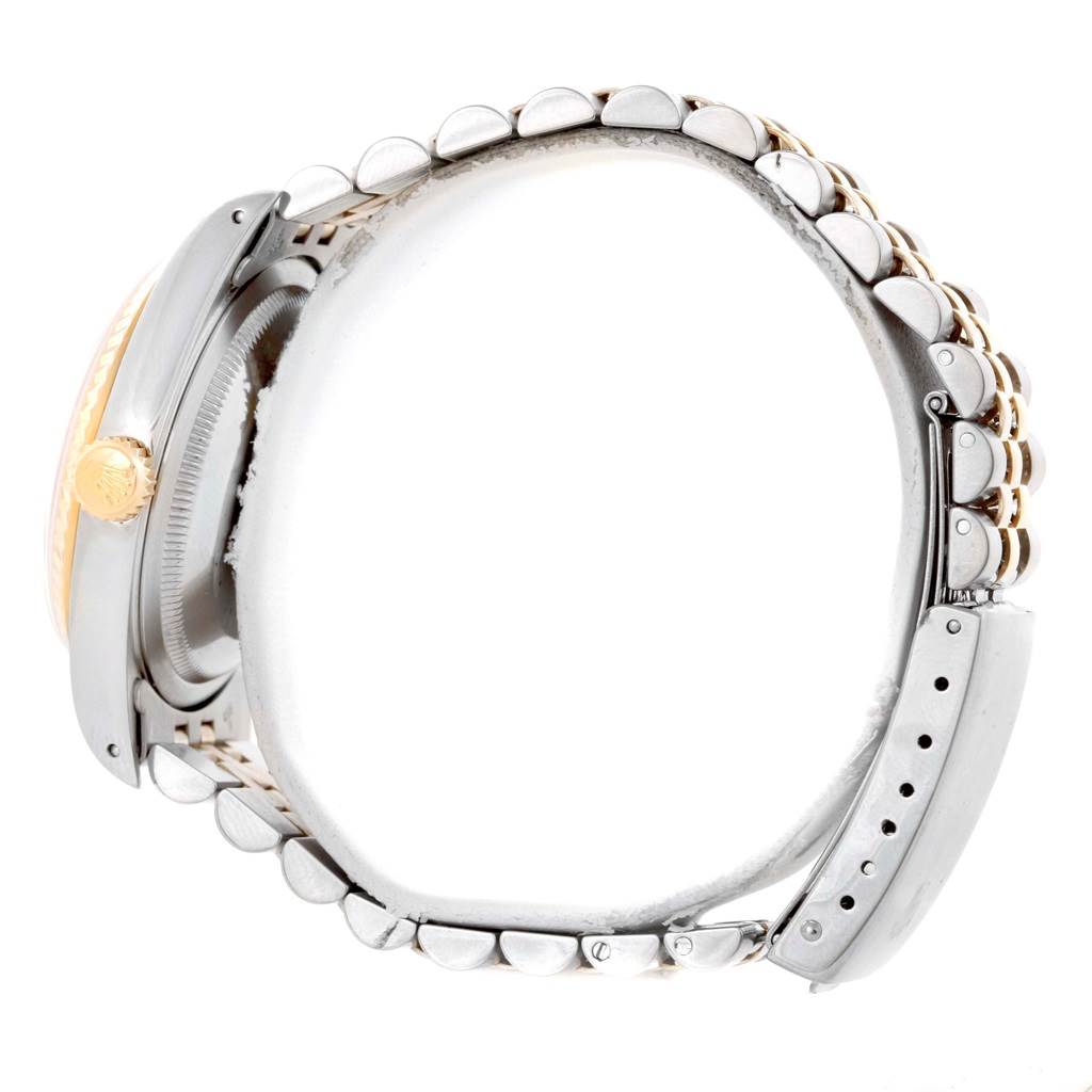 This side-view angle of the Rolex Datejust 16233 Men's Steel and Gold (two tone) Champagne Dial 16233 Men's Steel and Gold (two tone) Champagne Dial watch shows the crown, bezel, and part of the Jubilee bracelet with the clasp open.