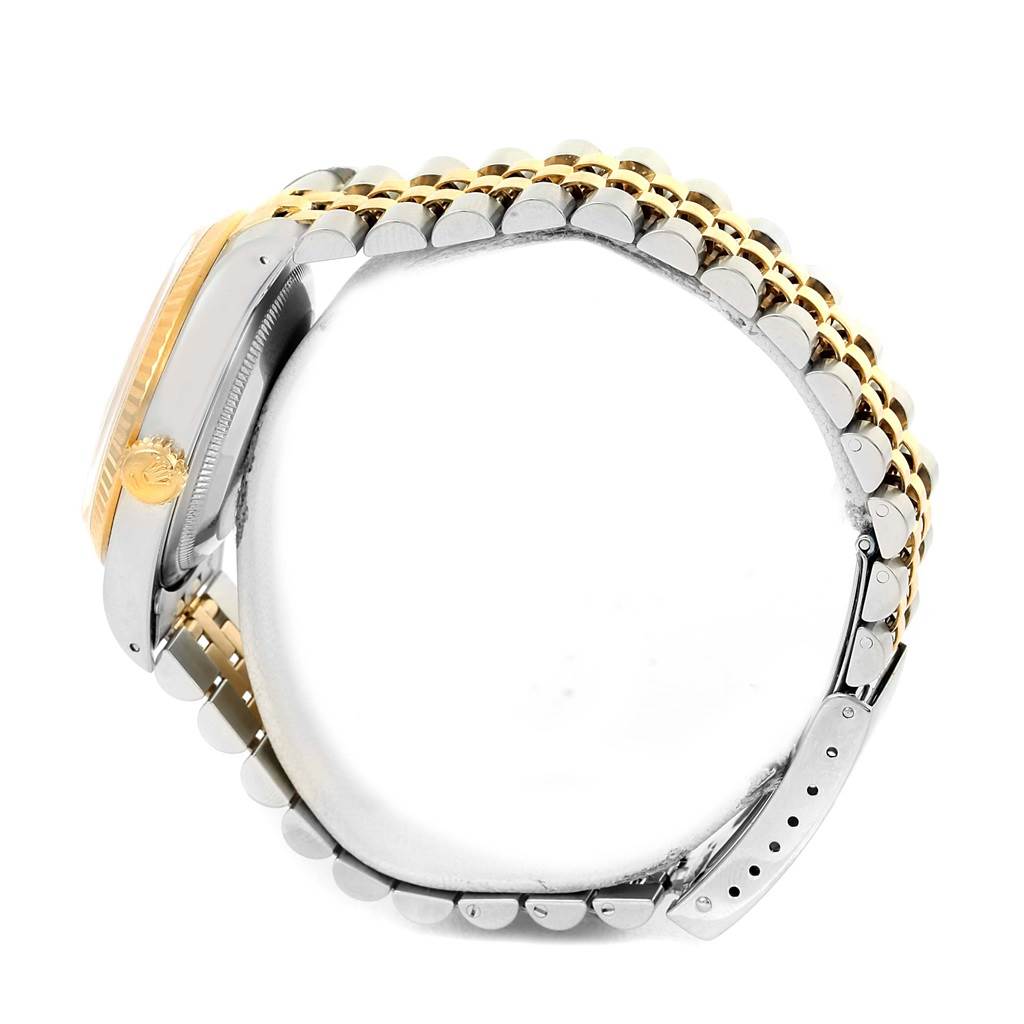 This image displays a Rolex Datejust 16233 Men's Steel and Gold (two tone) Champagne Dial 16233 Men's Steel and Gold (two tone) Champagne Dial watch from the side, focusing on the crown, bezel, and bracelet.