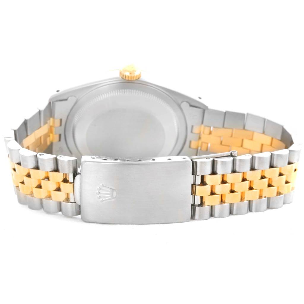 The image shows a rear view of a Rolex Datejust 16233 Men's Steel and Gold (two tone) Champagne Dial 16233 Men's Steel and Gold (two tone) Champagne Dial watch, focusing on its two-tone bracelet and closed clasp with the logo.