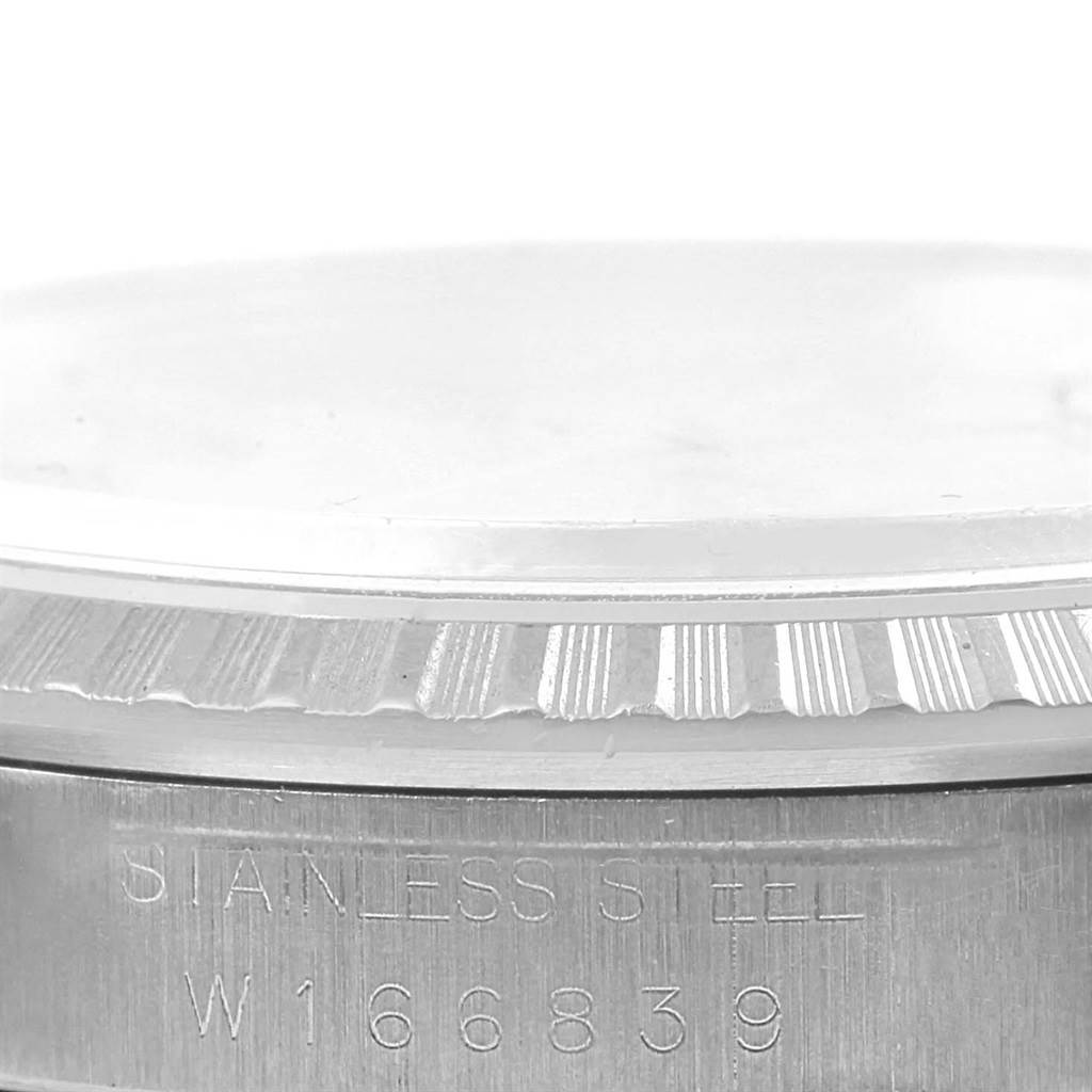 The image shows a close-up view of the bezel and a part of the case with engravings on a Rolex Datejust 16220 Men's Stainless Steel Silver Dial 16220 Men's Stainless Steel Silver Dial model.