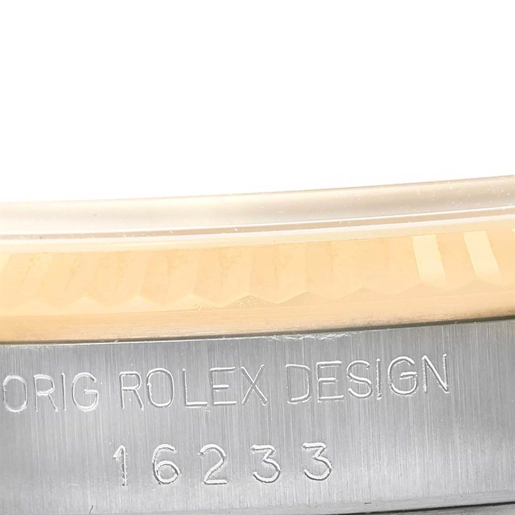 The image shows a close-up of the bezel and case of a Rolex Datejust 16233 Men's Steel and Gold (two tone) Champagne Dial 16233 Men's Steel and Gold (two tone) Champagne Dial model, with the inscription "ORIG ROLEX DESIGN 16233".