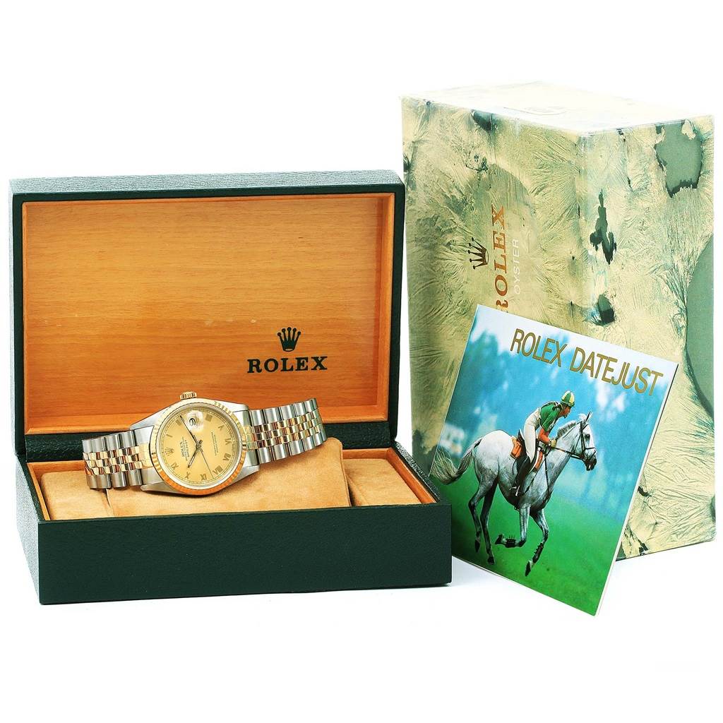 The Rolex Datejust 16233 Men's Steel and Gold (two tone) Champagne Dial 16233 Men's Steel and Gold (two tone) Champagne Dial watch is displayed in its open box along with its booklet and outer packaging.