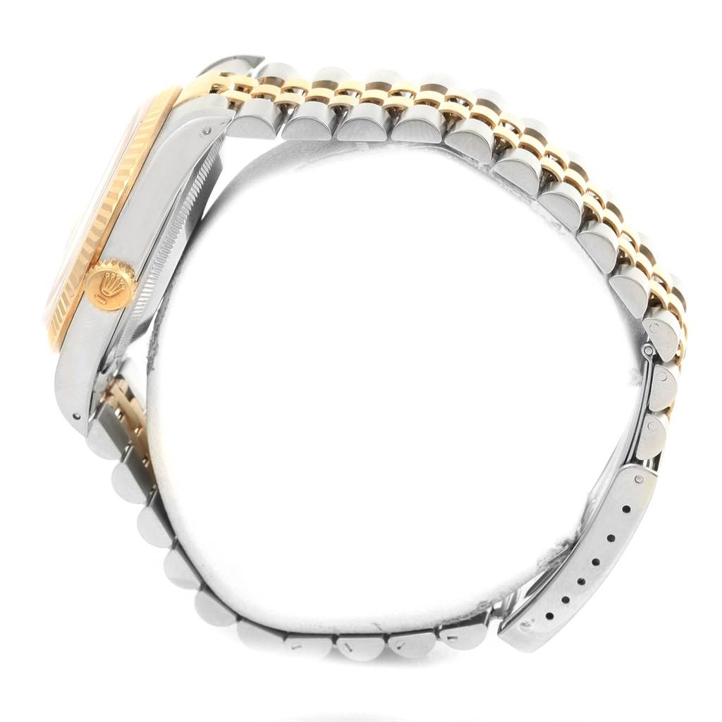 The Rolex Datejust 16233 Men's Steel and Gold (two tone) Champagne Dial 16233 Men's Steel and Gold (two tone) Champagne Dial watch is shown from a side angle, focusing on the case, crown, and two-tone bracelet.