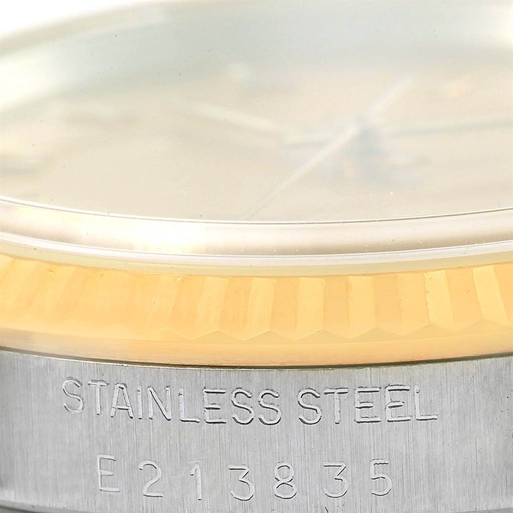 This image shows a detailed view of the stainless steel case and bezel of a Rolex Datejust 16233 Men's Steel and Gold (two tone) Champagne Dial 16233 Men's Steel and Gold (two tone) Champagne Dial watch.