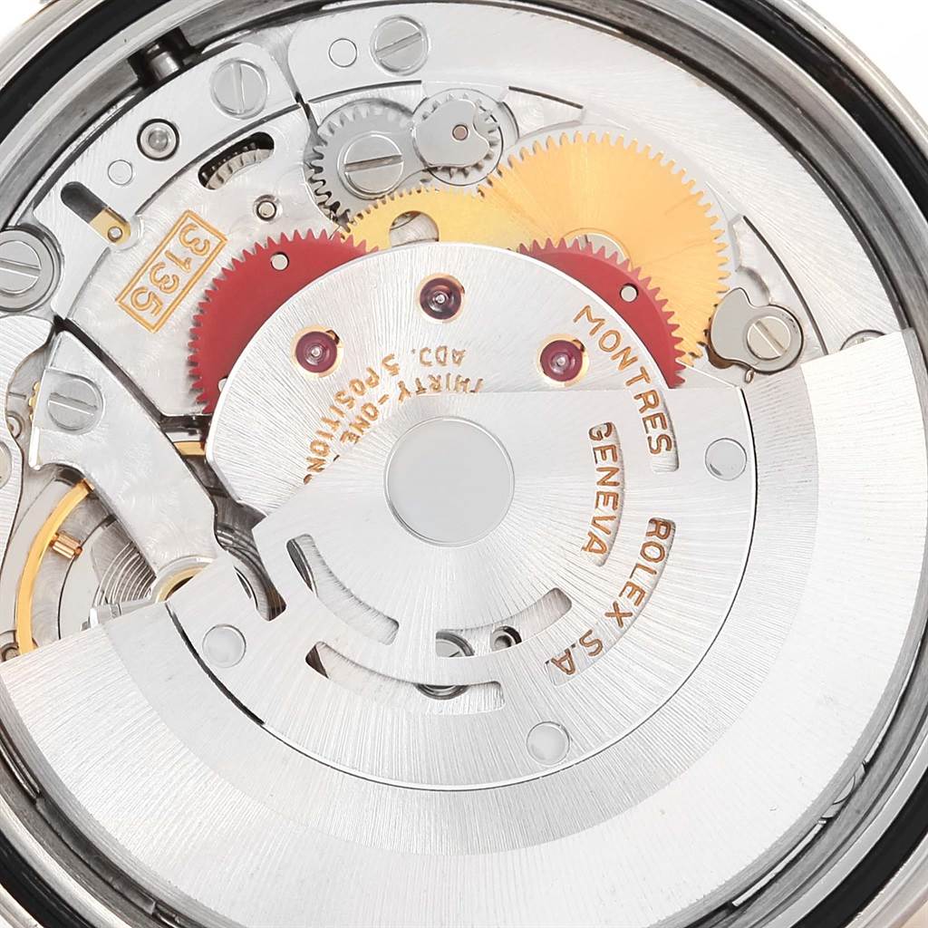 The image shows the intricate internal mechanism of a Rolex Datejust 16233 Men's Steel and Gold (two tone) Champagne Dial 16233 Men's Steel and Gold (two tone) Champagne Dial watch, highlighting gears and the rotor.