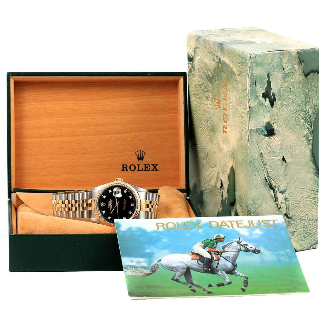 The Rolex Datejust 16233 Steel and Gold (two tone) Black Dial 16233 Steel and Gold (two tone) Black Dial watch is shown in its open box with a booklet and outer packaging visible.