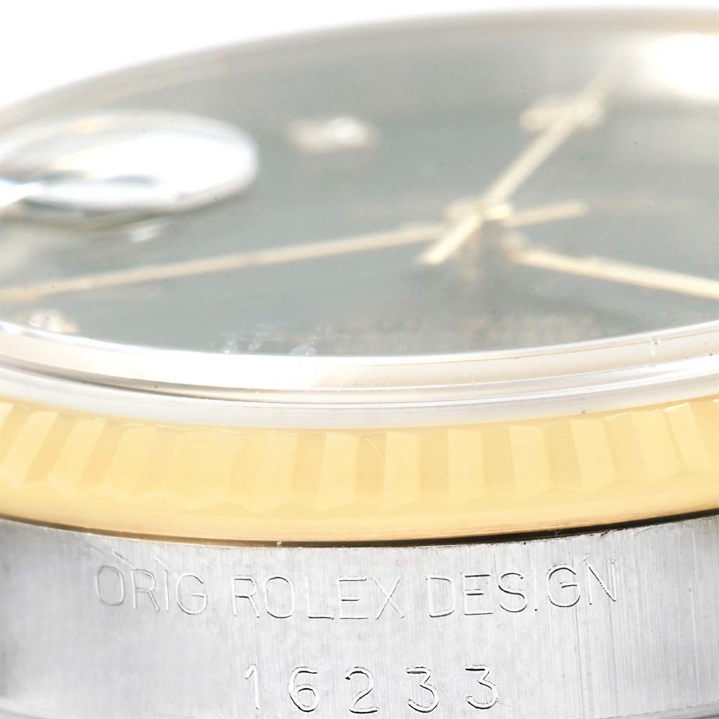 This image shows a close-up of the side profile of a Rolex Datejust 16233 Steel and Gold (two tone) Black Dial 16233 Steel and Gold (two tone) Black Dial model, highlighting its bezel, crystal, and case with inscribed model number 16233.