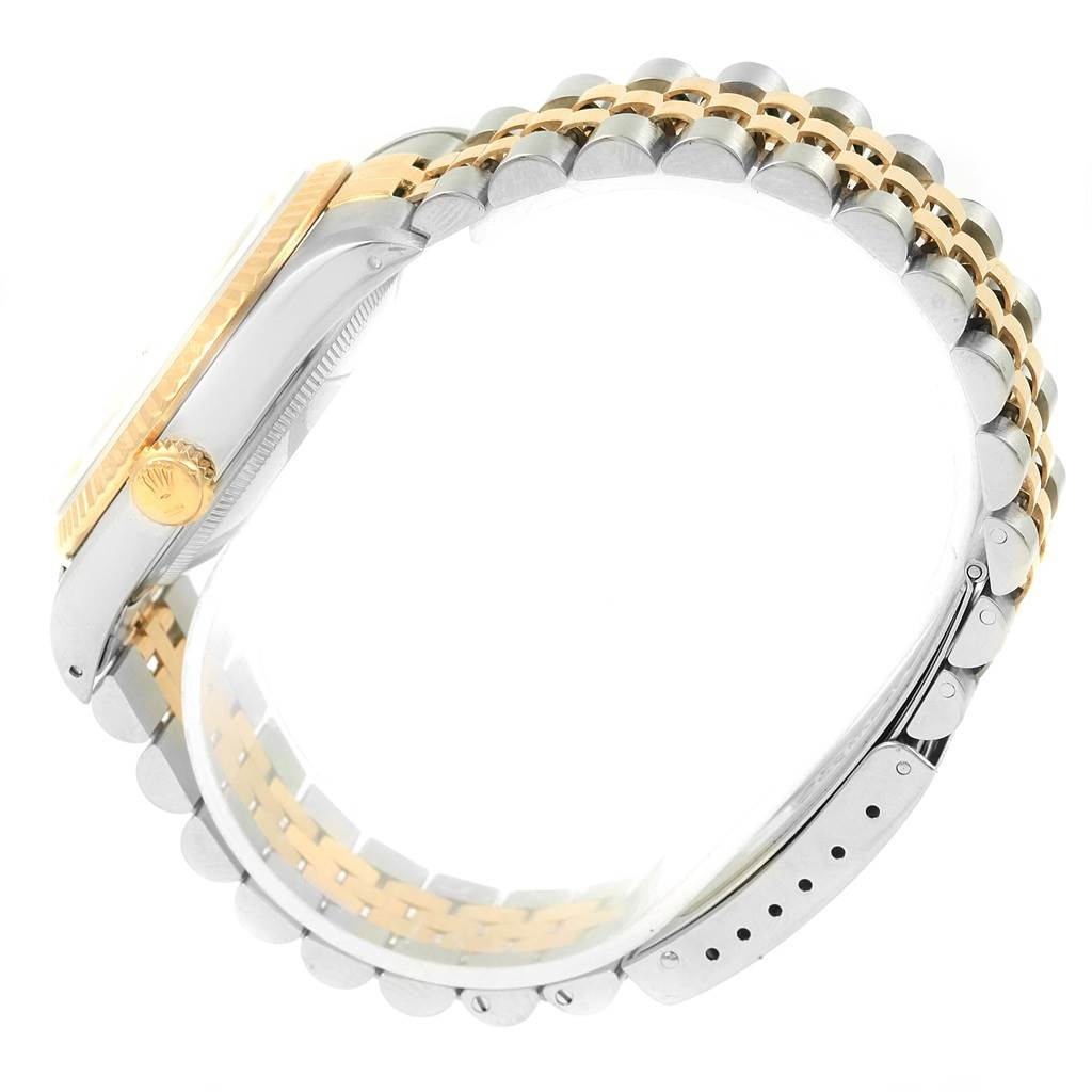 The image displays a side view of a Rolex Datejust 16233 Steel and Gold (two tone) Black Dial 16233 Steel and Gold (two tone) Black Dial watch, highlighting its two-tone bracelet and crown.