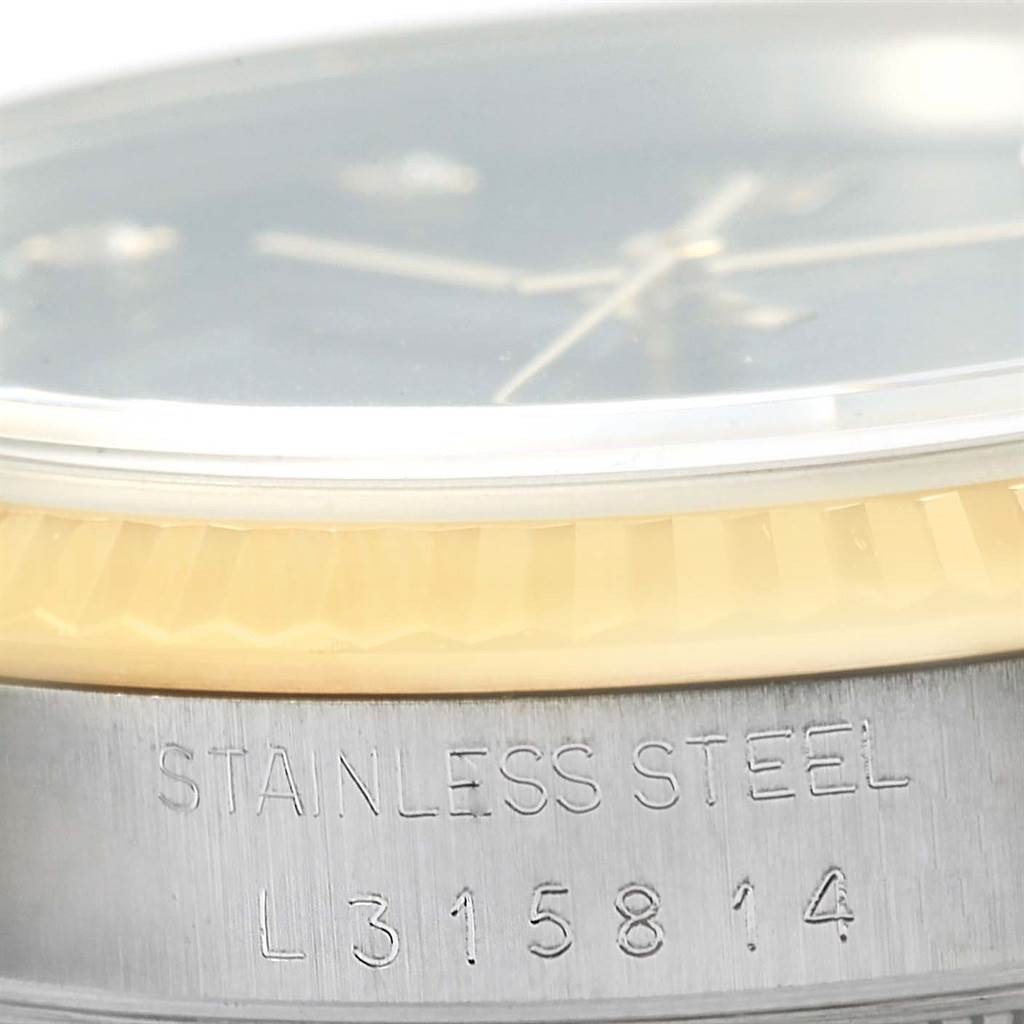 The image shows a close-up angle of the case side and bezel of a Rolex Datejust 16233 Steel and Gold (two tone) Black Dial 16233 Steel and Gold (two tone) Black Dial watch, with "STAINLESS STEEL" engraving visible.