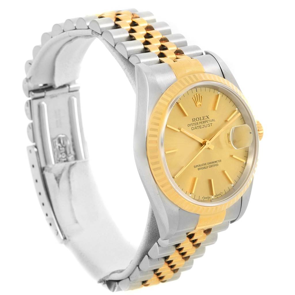 The watch, a Rolex Datejust 16233 Men's Steel and Gold (two tone) Champagne Dial 16233 Men's Steel and Gold (two tone) Champagne Dial model, is angled to show its face, gold and silver bracelet, cyclops date lens, and fluted bezel.