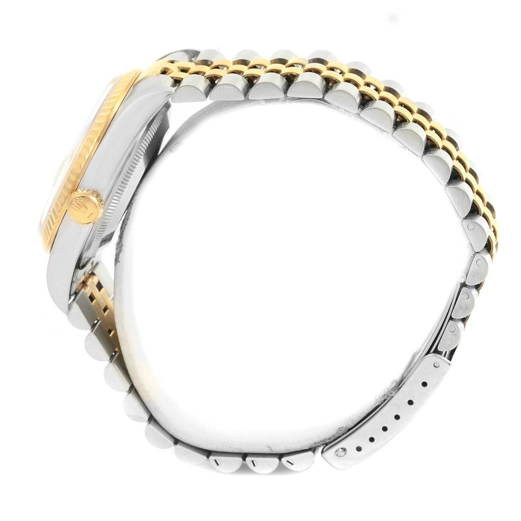 This side-angle view of the Rolex Datejust 16233 Men's Steel and Gold (two tone) Champagne Dial 16233 Men's Steel and Gold (two tone) Champagne Dial watch shows the crown, case, and part of the bracelet.