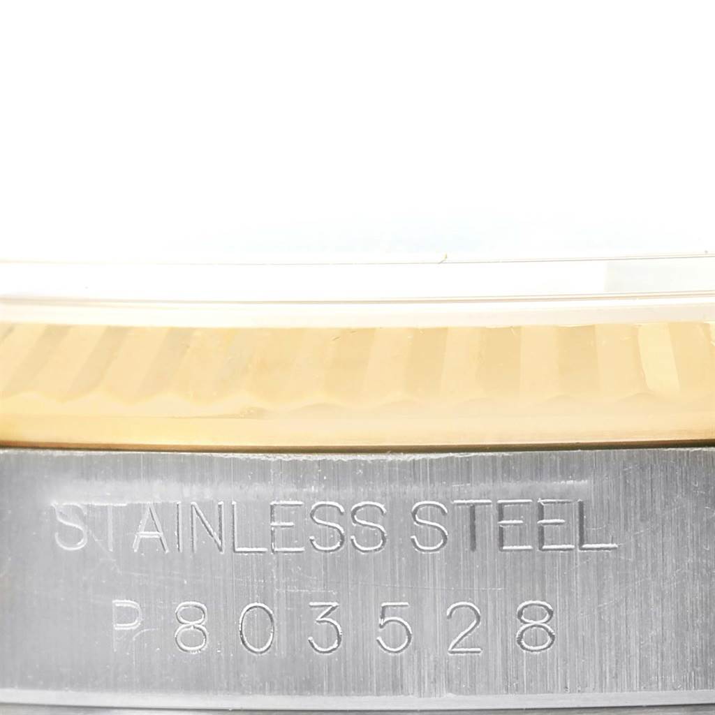 This close-up image shows the side of the stainless steel casing and bezel of the Rolex Datejust 16233 Men's Steel and Gold (two tone) White Dial 16233 Men's Steel and Gold (two tone) White Dial model, highlighting the serial number.