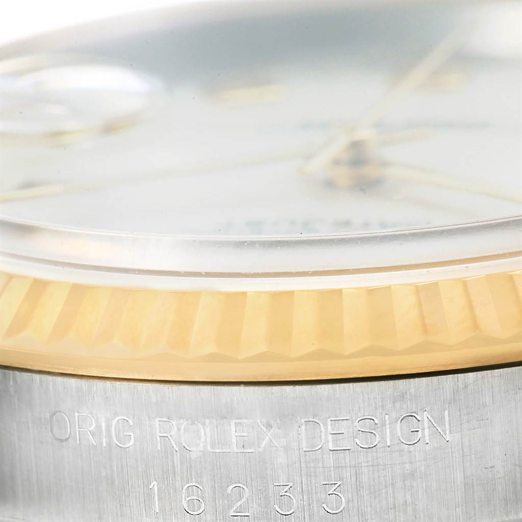 The image shows a close-up side angle of the bezel, crystal, and engraving on a Rolex Datejust 16233 Men's Steel and Gold (two tone) Beige Dial 16233 Men's Steel and Gold (two tone) Beige Dial model.
