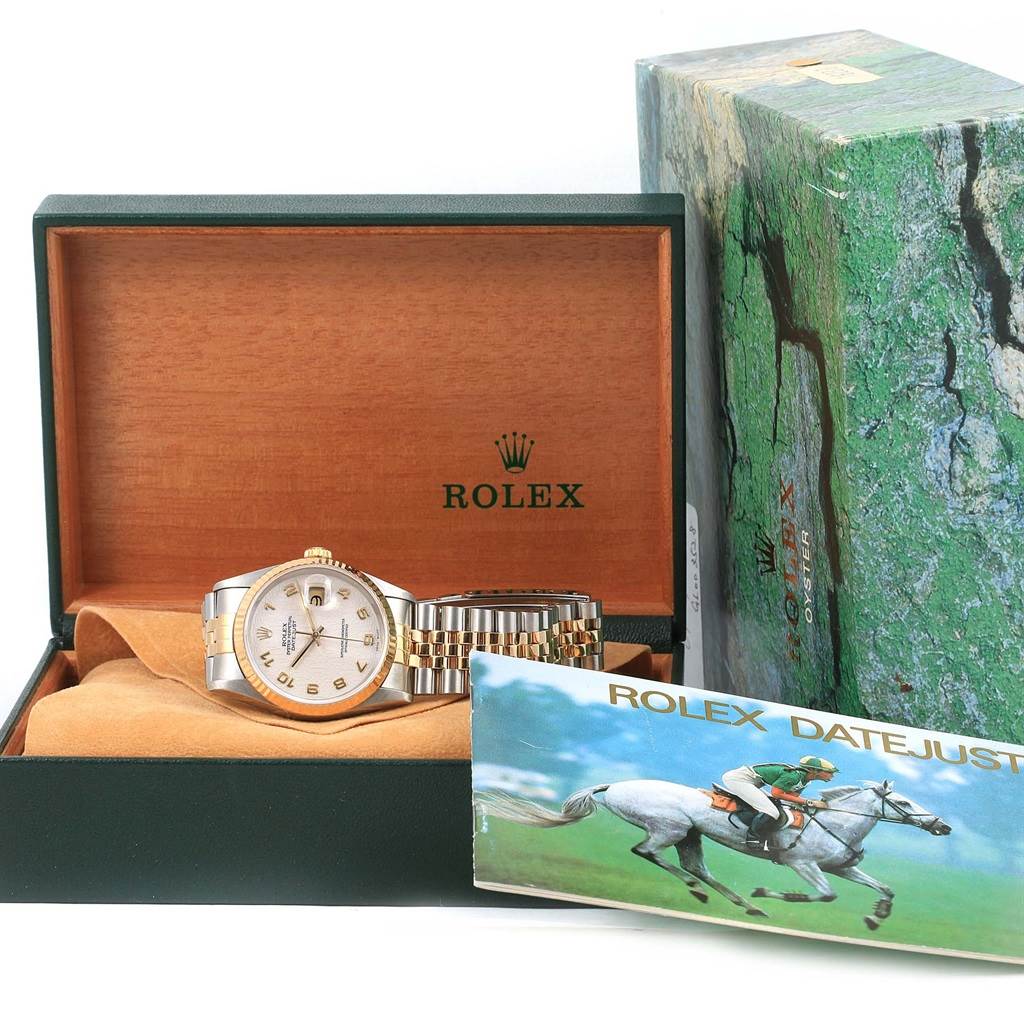 The Rolex Datejust 16233 Men's Steel and Gold (two tone) Beige Dial 16233 Men's Steel and Gold (two tone) Beige Dial watch is shown front-facing inside its open box, accompanied by a booklet and outer packaging.