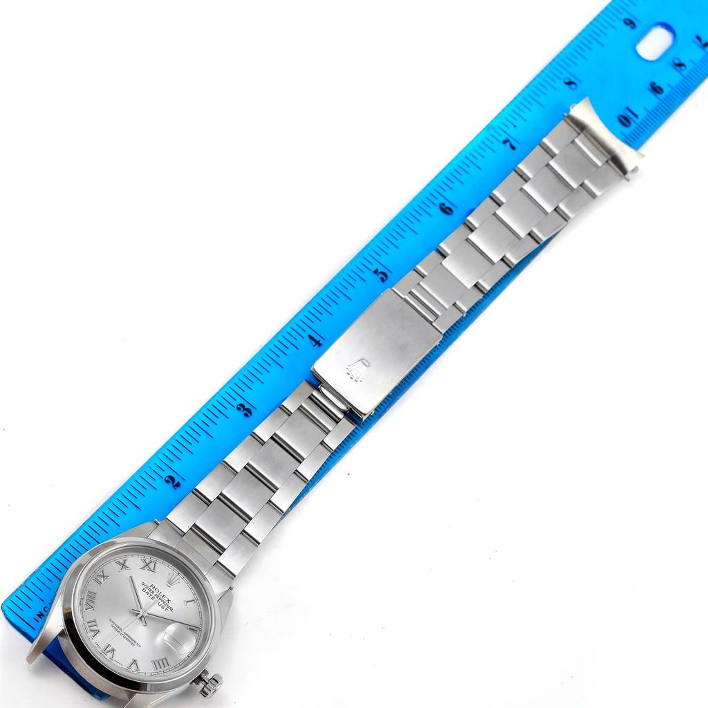 The image shows a Rolex Datejust 16200 Men's Stainless Steel Grey Dial 16200 Men's Stainless Steel Grey Dial watch laid flat with its bracelet extended along a ruler for measurement.