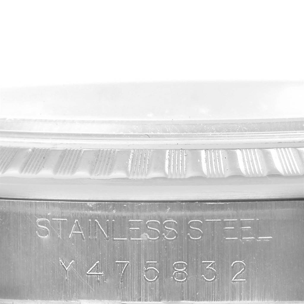 This image shows a close-up of the serial number and part of the bezel on a Rolex Datejust 16220 Men's Stainless Steel White Dial 16220 Men's Stainless Steel White Dial watch.
