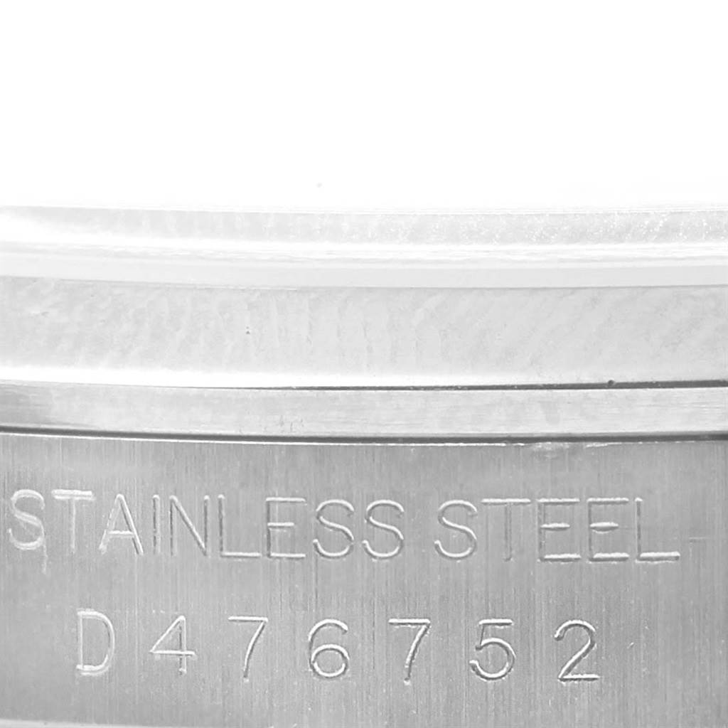 This close-up image shows the side of the stainless steel case back of a Rolex Datejust 16200 Men's Stainless Steel Silver Dial 16200 Men's Stainless Steel Silver Dial watch, featuring its serial number.