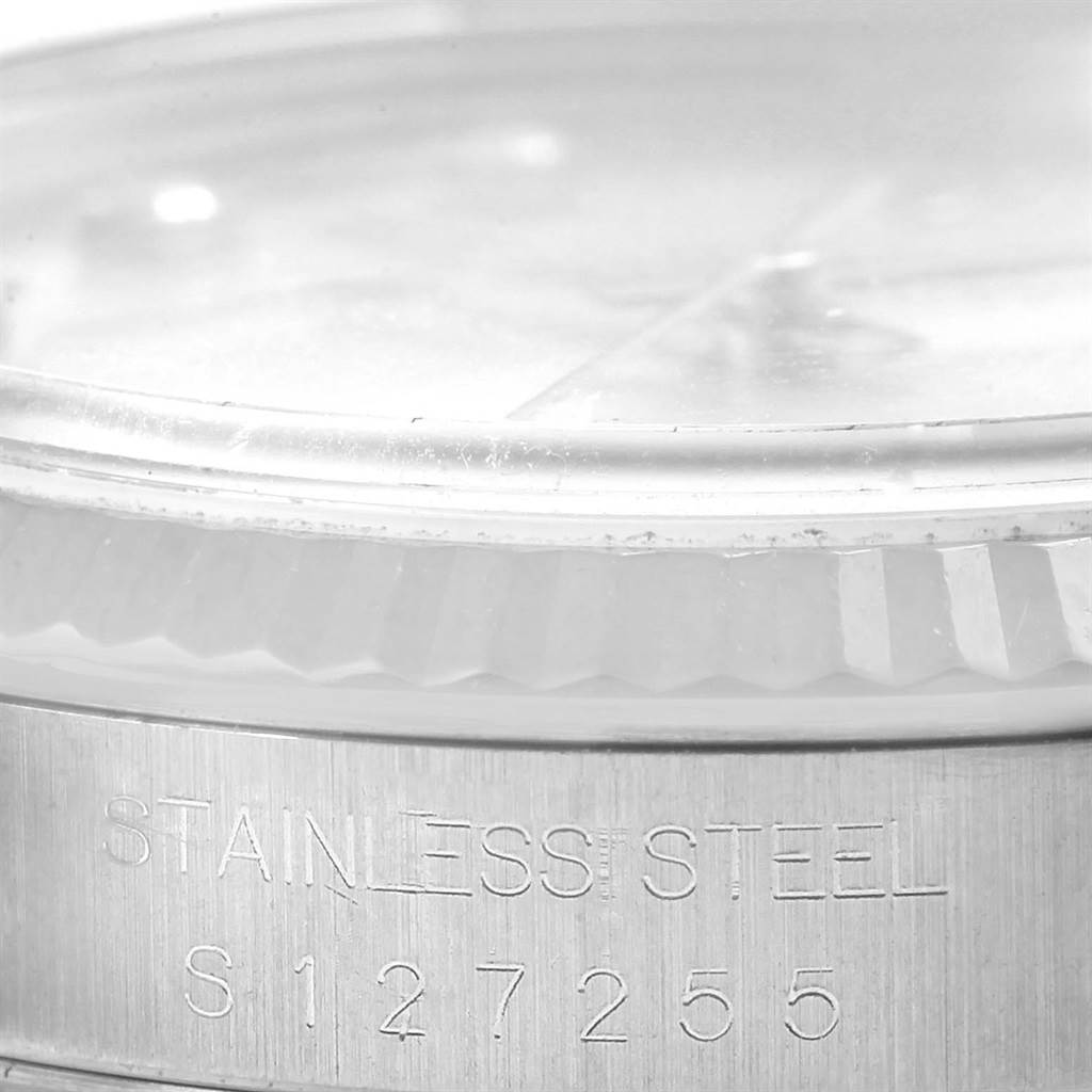 This close-up image of the Rolex Datejust 16234 Men's Stainless Steel Silver Dial 16234 Men's Stainless Steel Silver Dial shows part of the watch's bezel and case, emphasizing the stainless steel material and serial number.