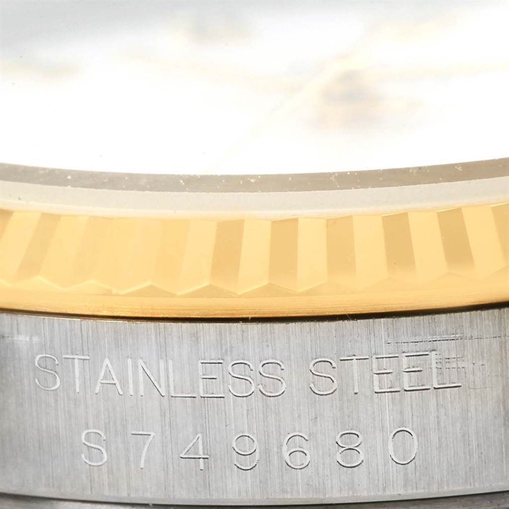 The image shows a close-up of the Rolex Datejust 16233 Men's Steel and Gold (two tone) White Dial 16233 Men's Steel and Gold (two tone) White Dial's bezel, dial edge, and engraved stainless steel case.