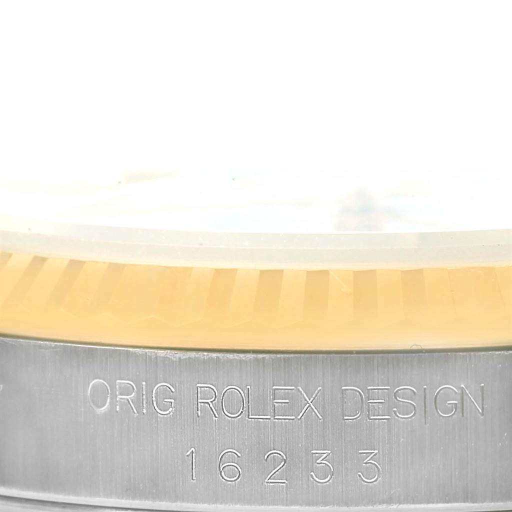 The image shows a close-up of the serial number and fluted bezel of a Rolex Datejust 16233 Men's Steel and Gold (two tone) White Dial 16233 Men's Steel and Gold (two tone) White Dial model, showcasing the text "ORIG ROLEX DESIGN."