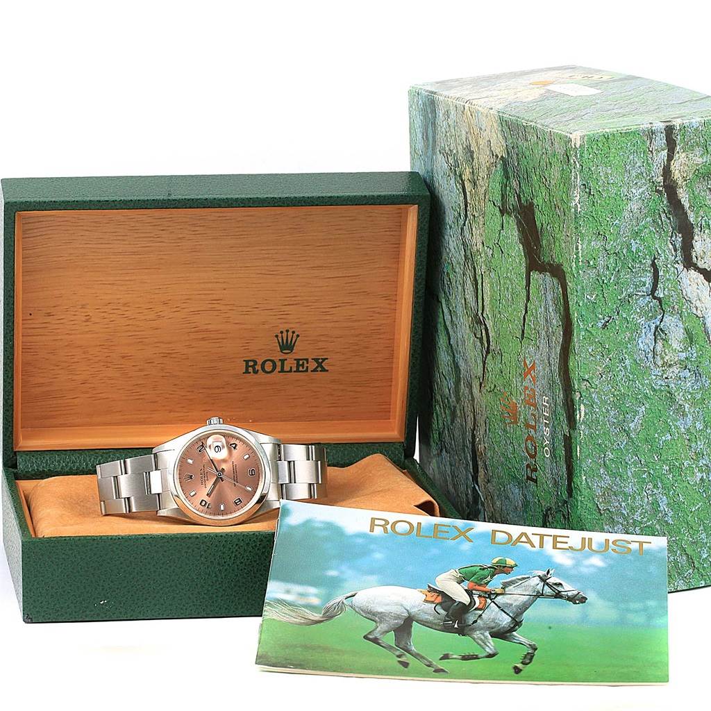 The image shows a Rolex Datejust 15200 Men's Stainless Steel Pink Dial 15200 Men's Stainless Steel Pink Dial watch in its open box, with the outer box and a booklet beside it.