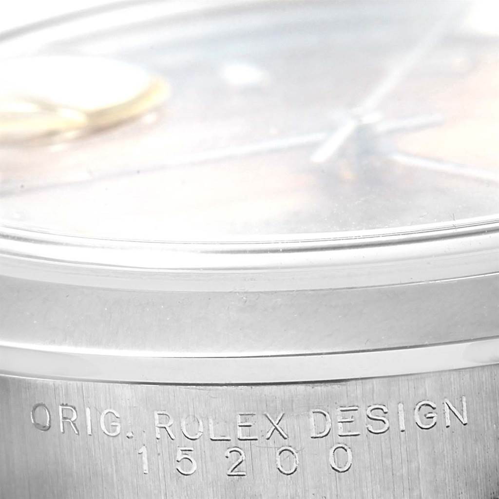 This close-up image shows the side of a Rolex Datejust 15200 Men's Stainless Steel Pink Dial 15200 Men's Stainless Steel Pink Dial watch, highlighting the "ORIG. ROLEX DESIGN" engraving and model number 15200.
