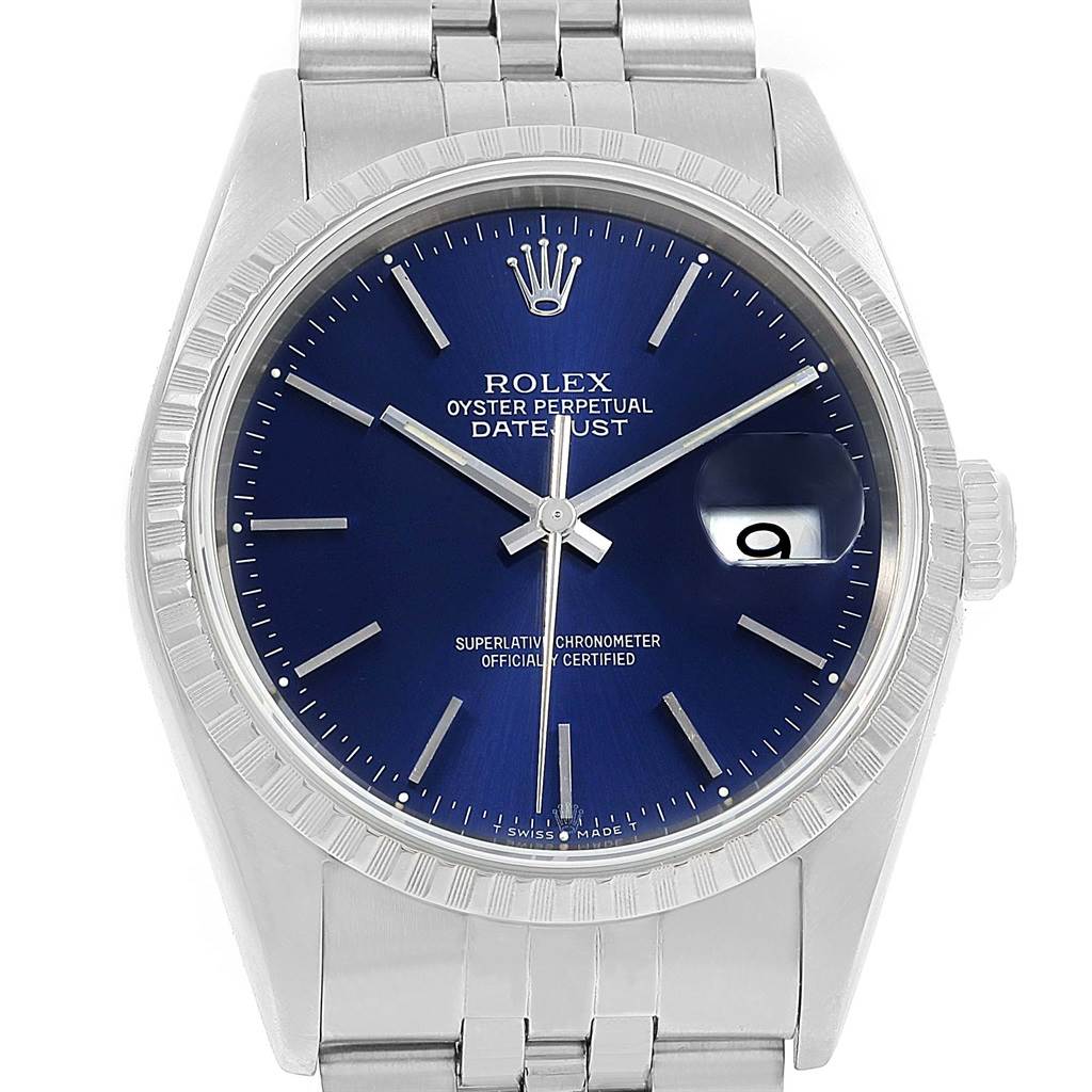 The image shows a front angle of a Rolex Datejust 16220 Men's Stainless Steel Blue Dial 16220 Men's Stainless Steel Blue Dial watch, highlighting its blue dial, fluted bezel, and date window with cyclops lens.