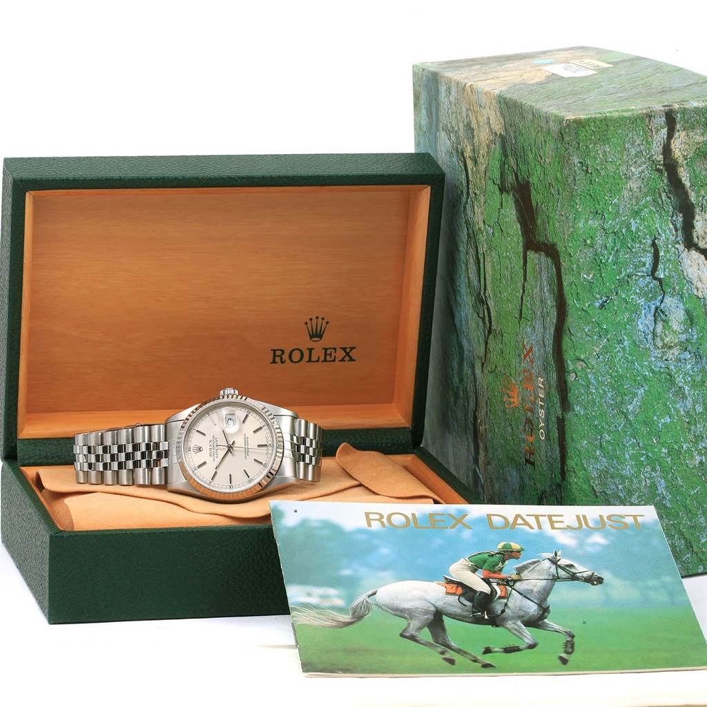 The image shows a Rolex Datejust 16234 Men's Stainless Steel Silver Dial 16234 Men's Stainless Steel Silver Dial watch in its box with the manual and outer box visible.