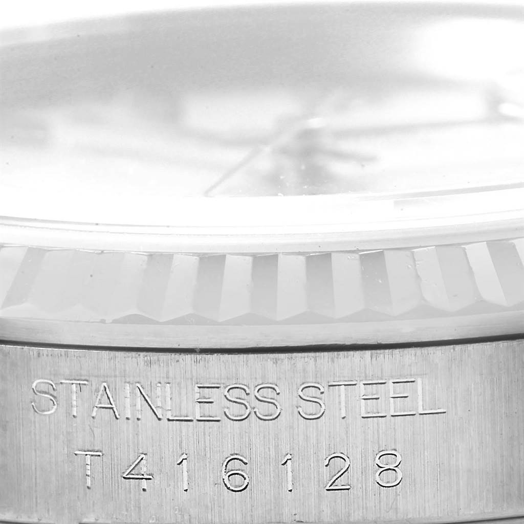 This close-up image shows the side view of the stainless steel case and bezel of a Rolex Datejust 16234 Men's Stainless Steel Silver Dial 16234 Men's Stainless Steel Silver Dial watch with engraving.