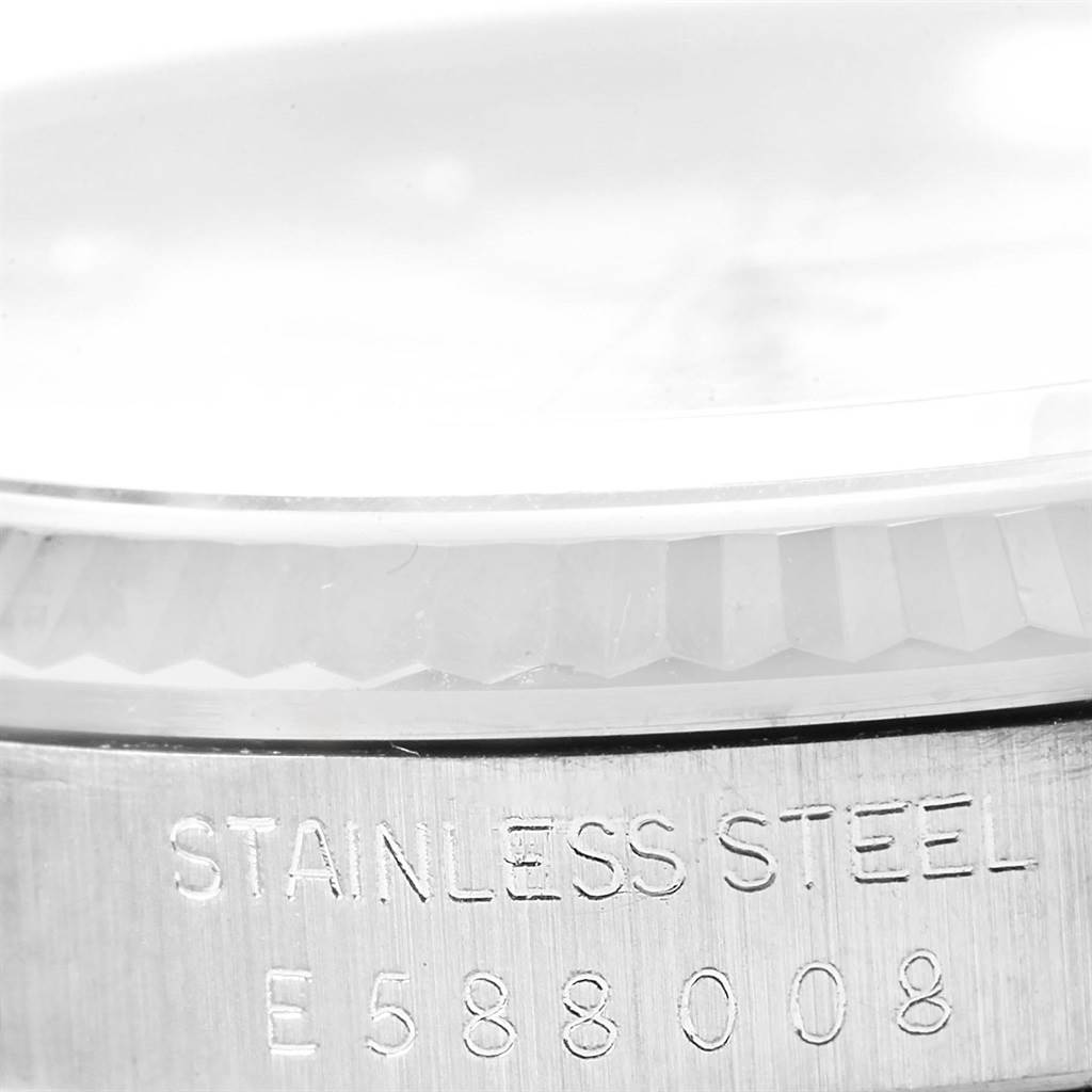 This close-up image shows the side engraving of a stainless steel Rolex Datejust 16234 Stainless Steel Silver Dial 16234 Stainless Steel Silver Dial watch, highlighting the serial number details.