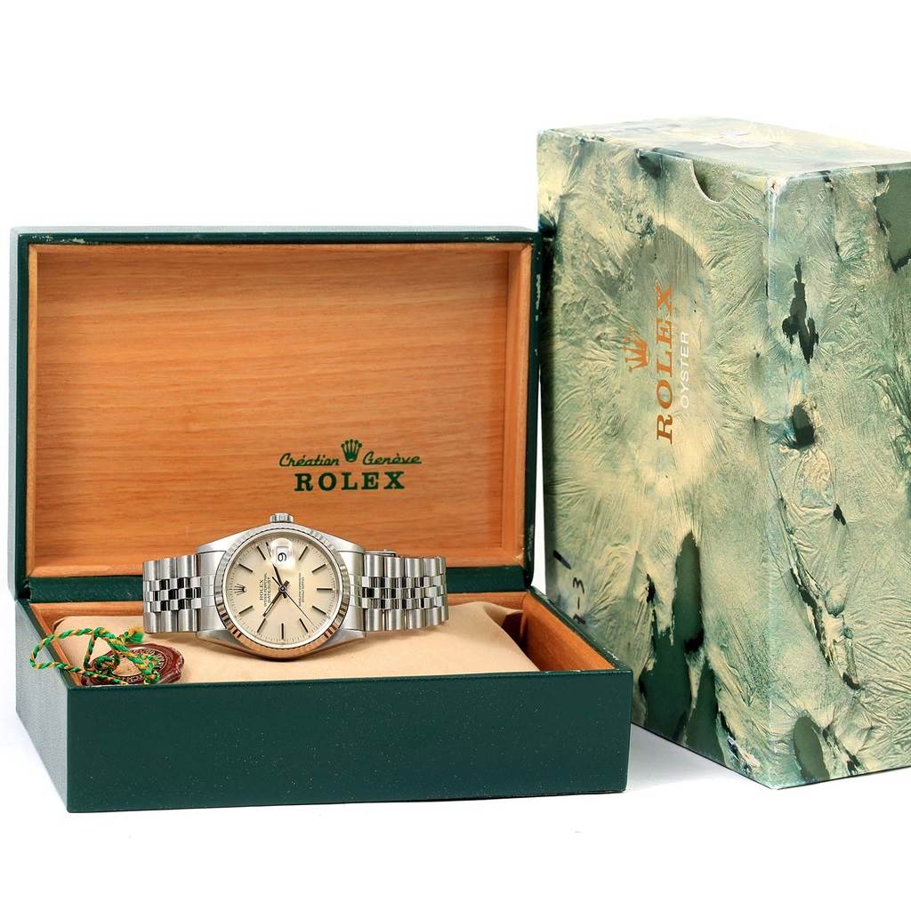 The Rolex Datejust 16234 Men's Stainless Steel Silver Dial 16234 Men's Stainless Steel Silver Dial watch is shown from a front angle, placed inside an open wooden Rolex box with green detailing and outer packaging.