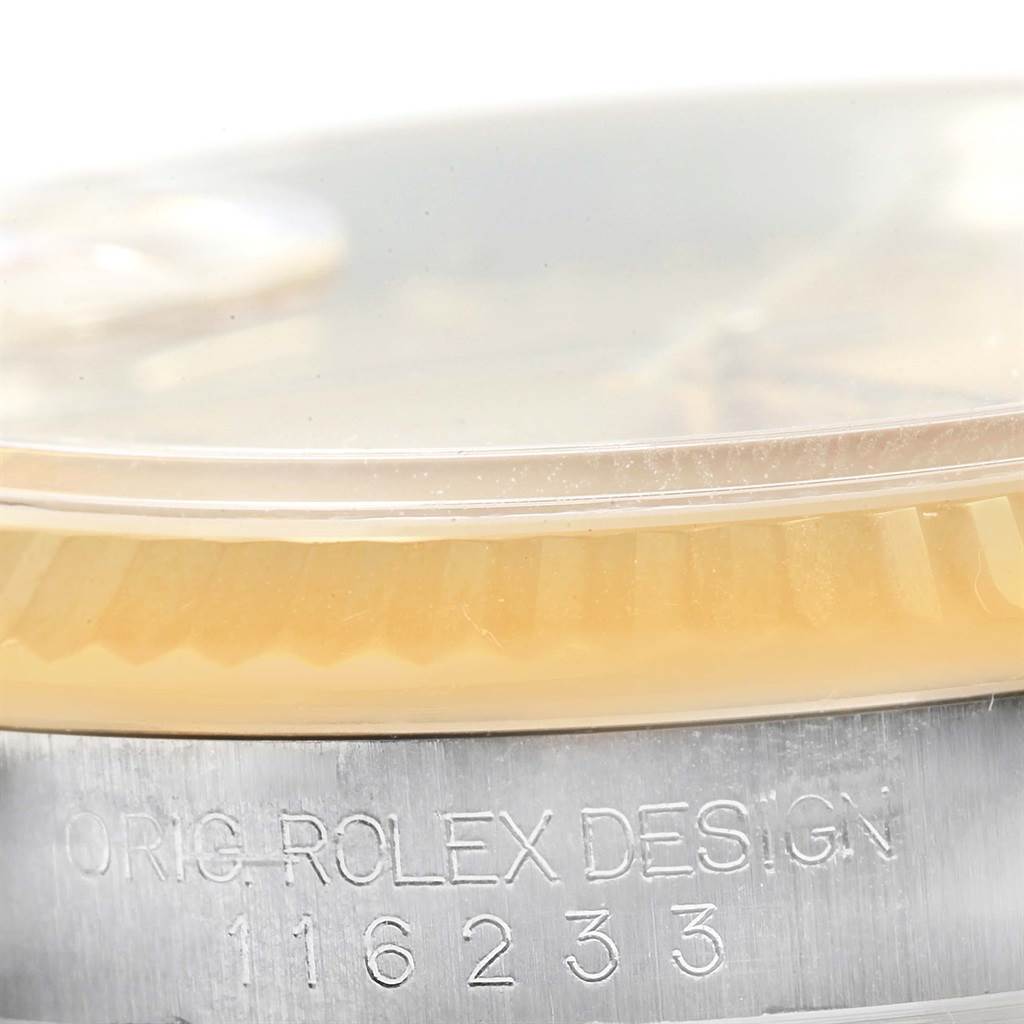 This image shows a close-up of the side of a Rolex Datejust 116233 Men's Stainless Steel Champagne Dial 116233 Men's Stainless Steel Champagne Dial watch, highlighting part of the bezel and engraved reference number.