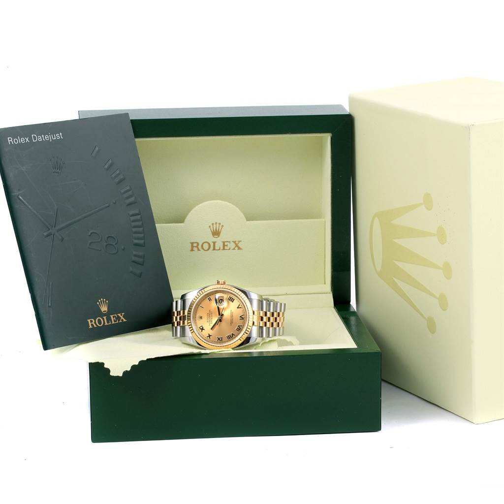 The Rolex Datejust 116233 Men's Stainless Steel Champagne Dial 116233 Men's Stainless Steel Champagne Dial watch is displayed head-on inside its green and gold box, accompanied by a manual.